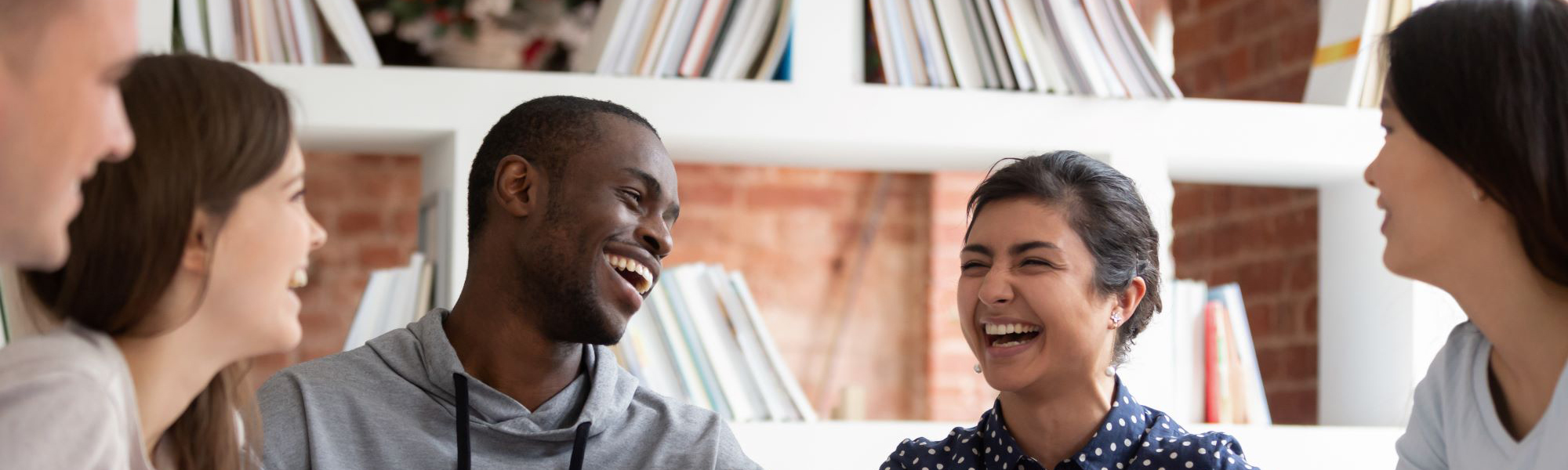 College students laughing together at a table