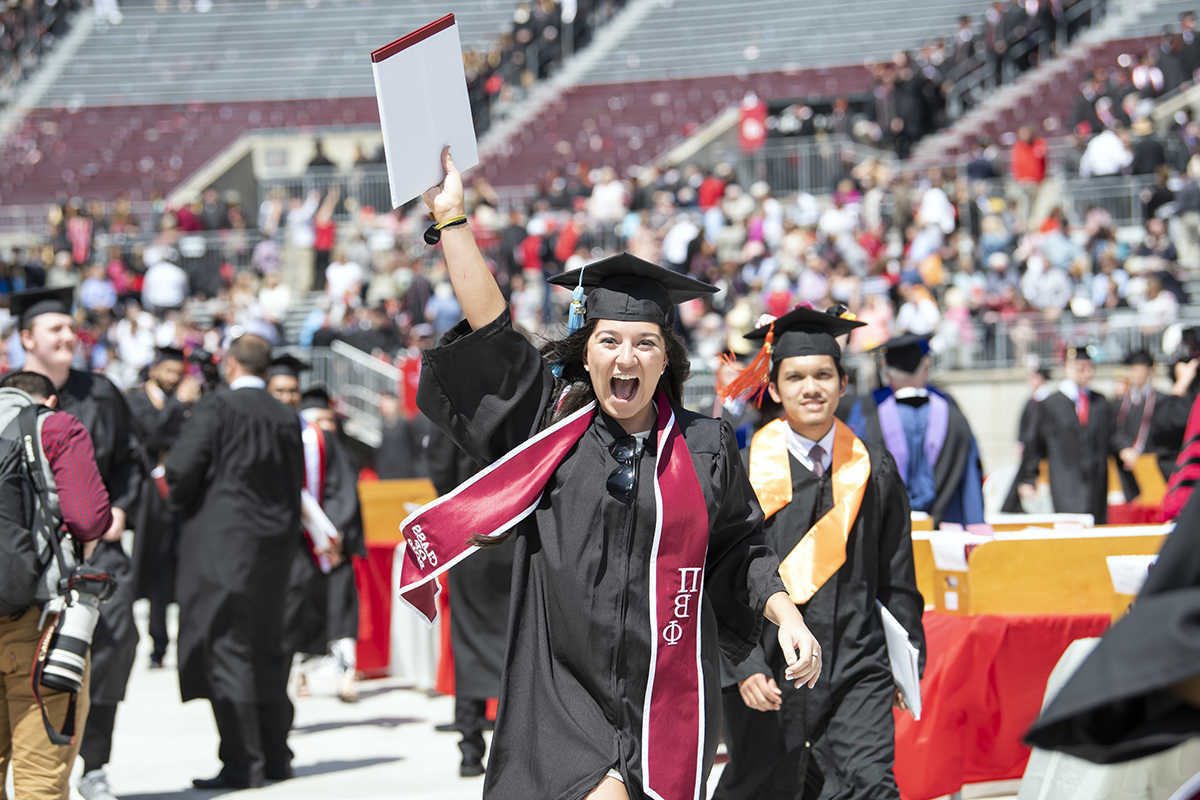 jubilant Ohio State grad raises her diploma above her head