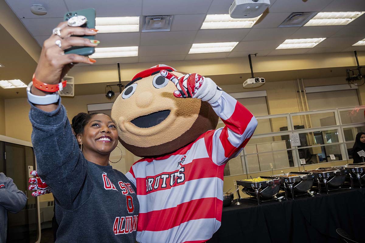 Brutus Buckeye takes a selfie with an ODI Homecoming attendee