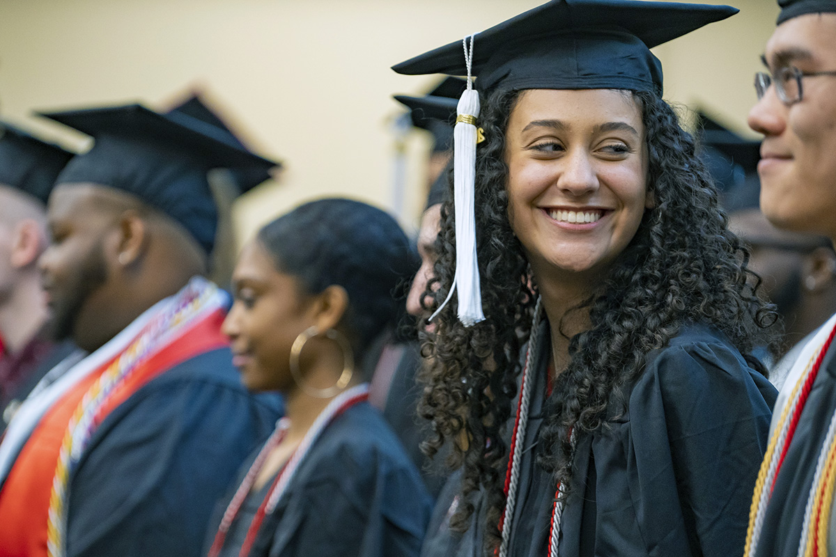 ODI grads smile at each other