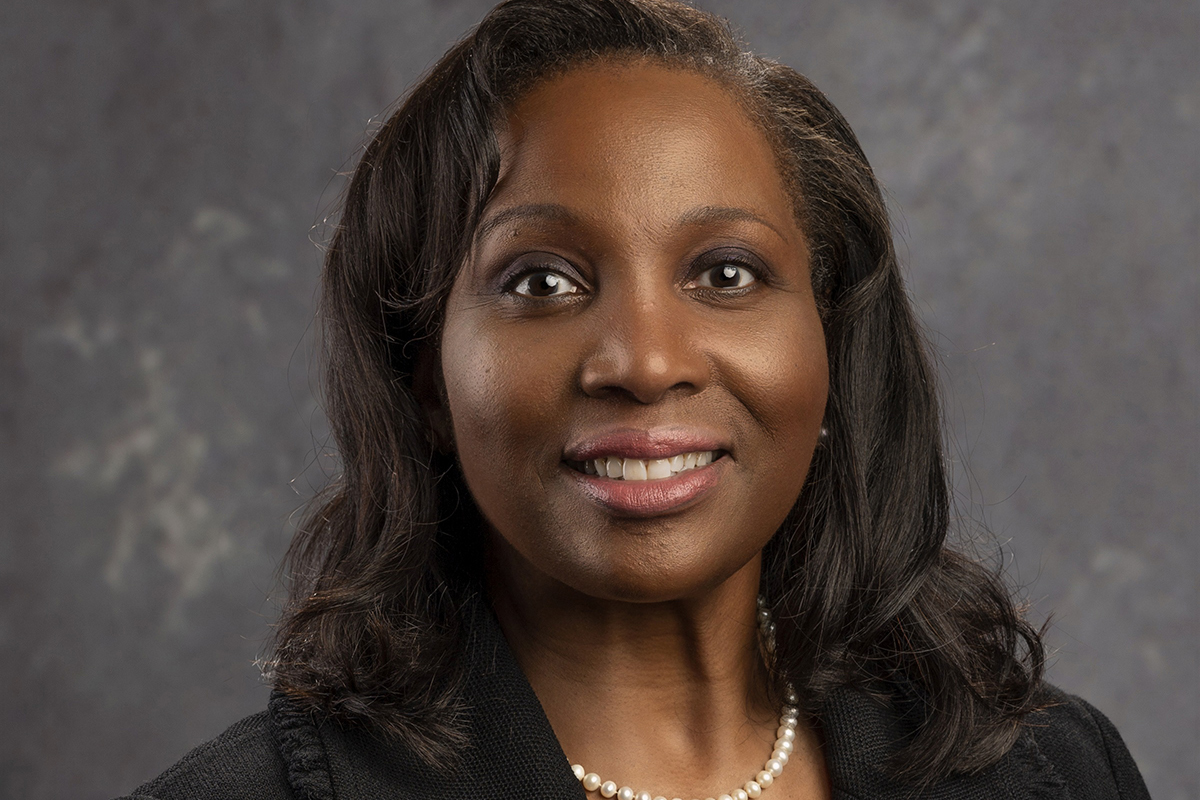 Lisa Cook, a Black woman in a black suit with pearls.