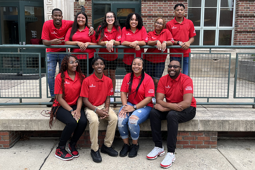 YSP Student Success coaches sit on step in red YSP shirts