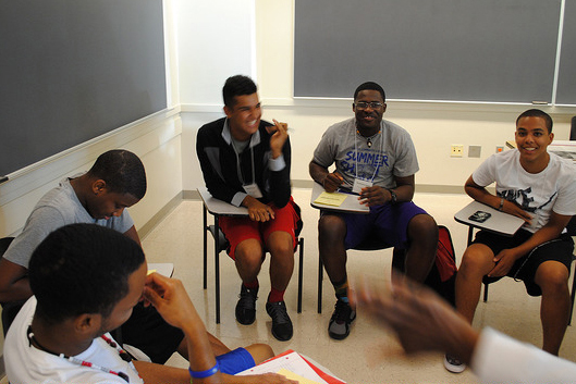 Group of males sitting at desks