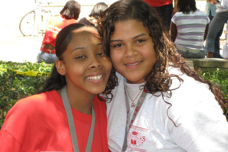 Two Young Scholar girls smiling for the camera