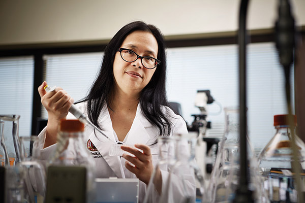 Woman in a lab coat work in a science lab