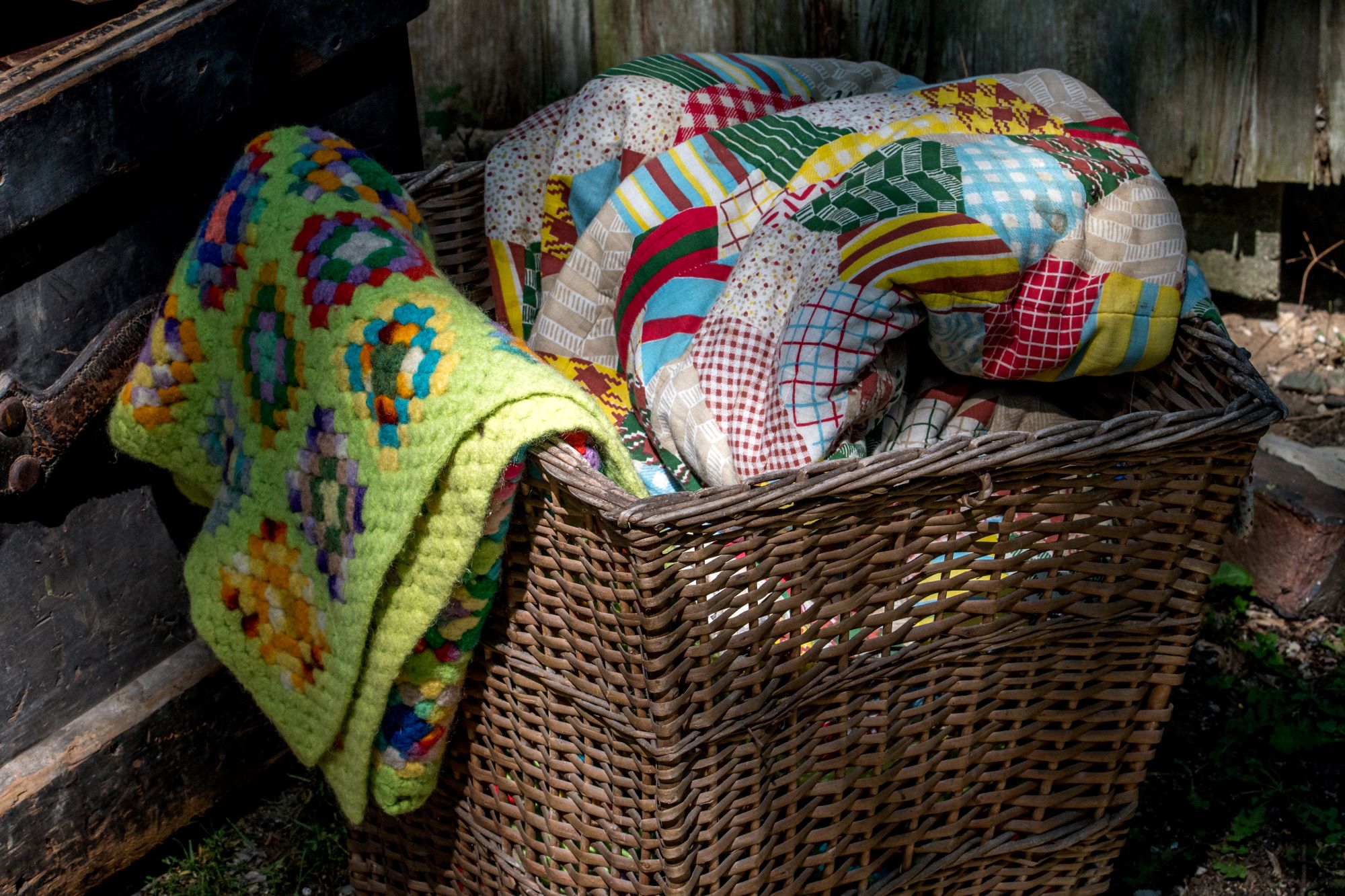 colorful blankets piled into a woven basket