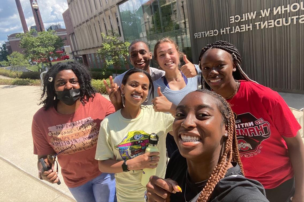 Six students take a selfie outside the Wilce Student Health Center