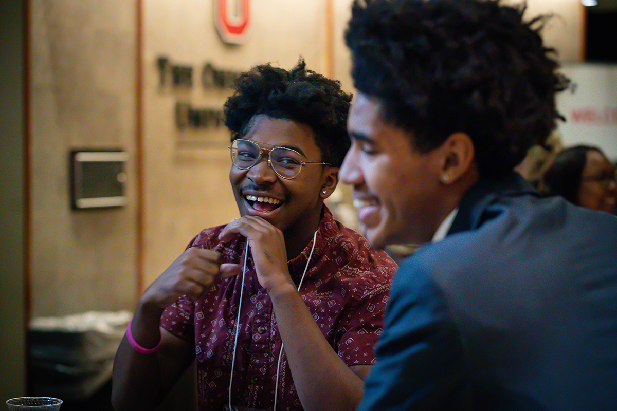 Two Balck men laugh together