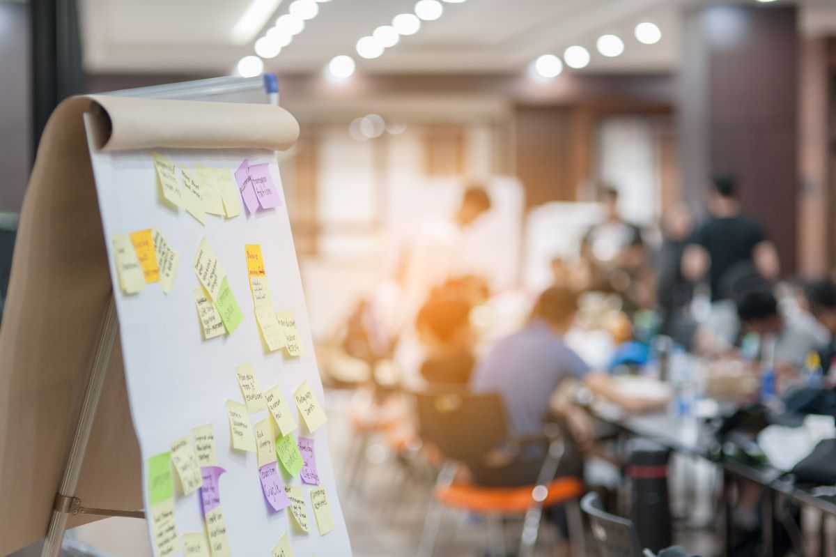 Board with post-it notes on it during meeting