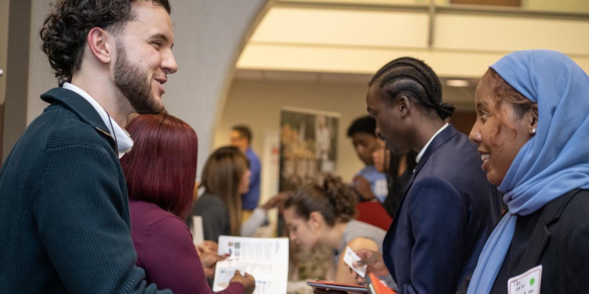 Recruiter talks to student in hijab