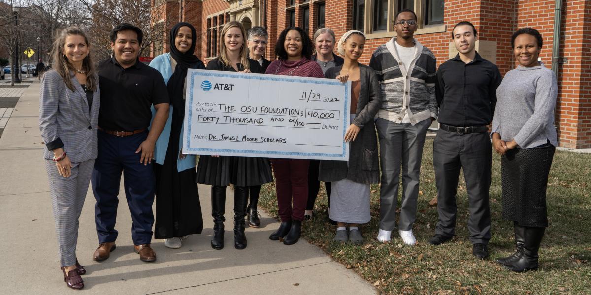 Diverse JLM Scholars and AT&T representatives hold a $40,000 check