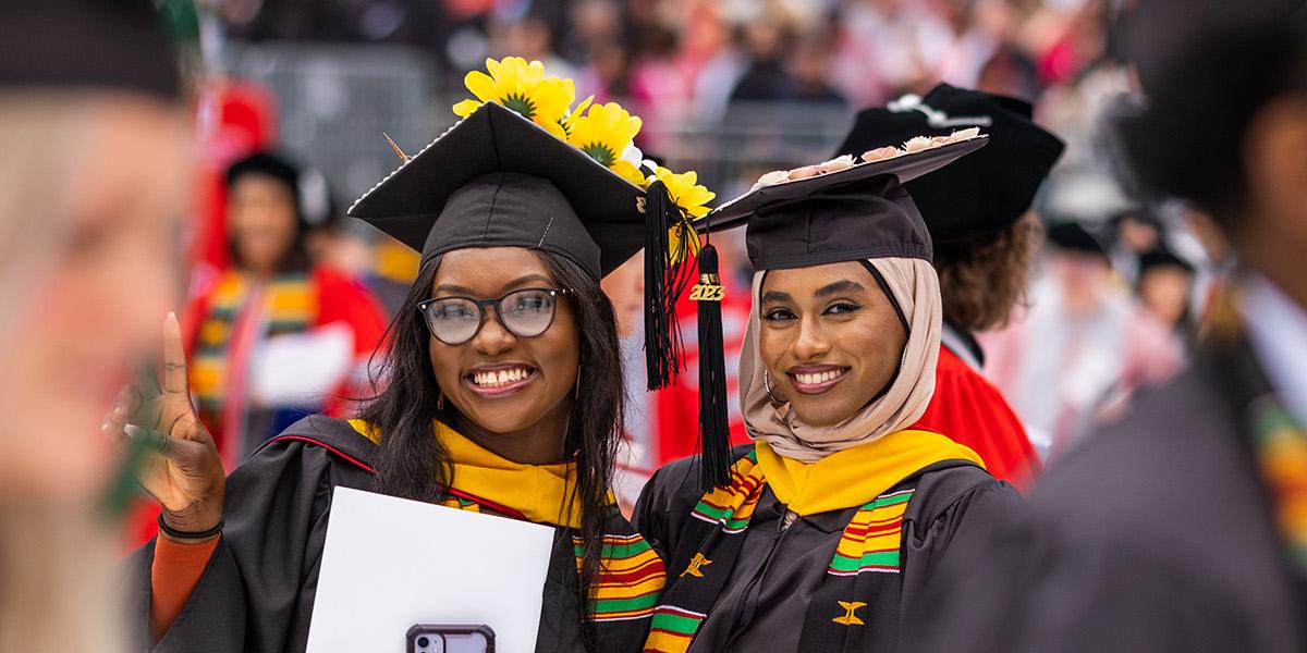 Two Ohio State grads in colorful stoles