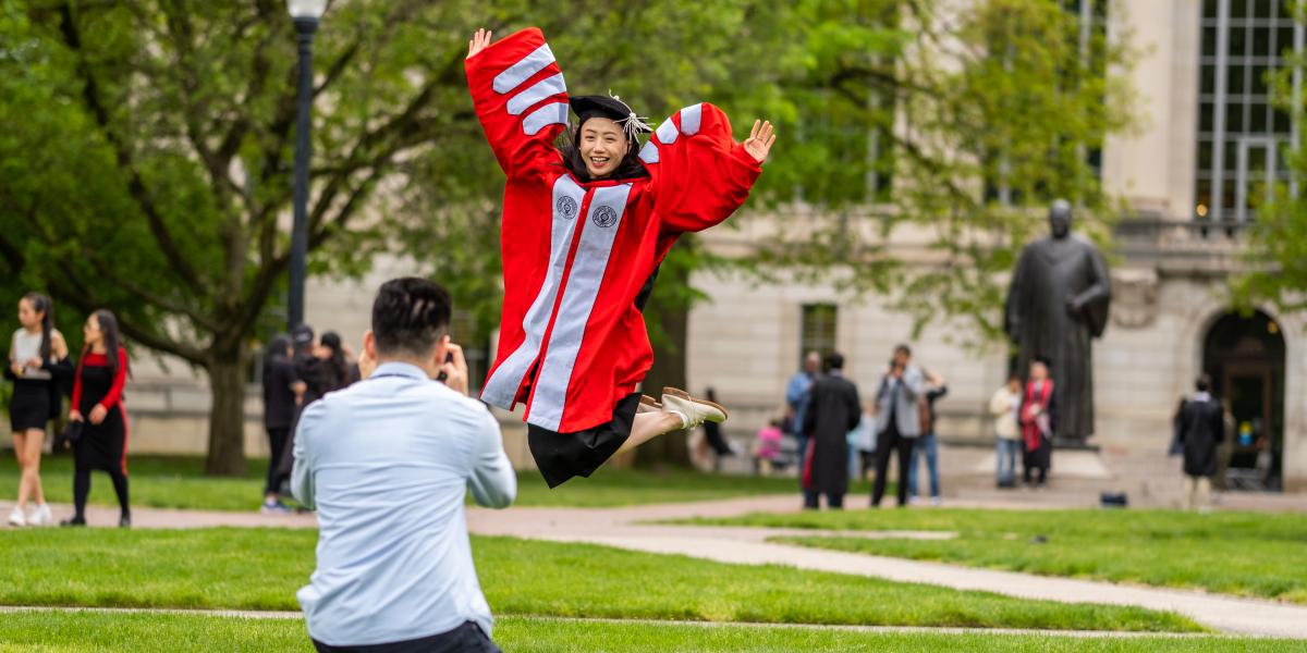 Graduating phd student jumps up into the air!