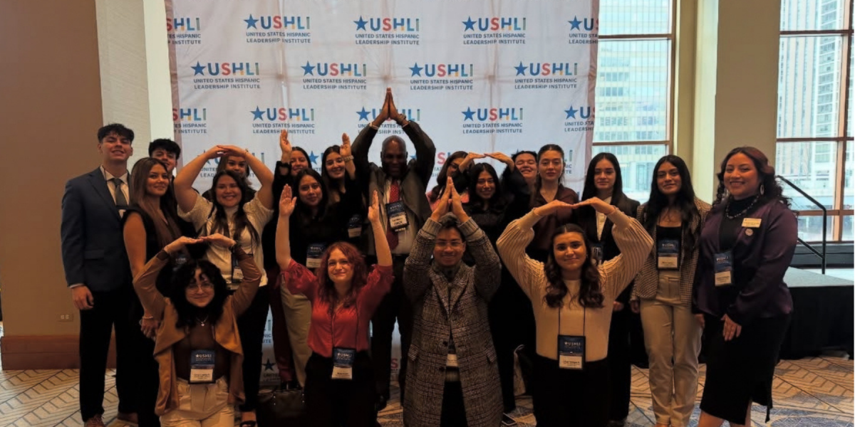 a group of LSS students at the United States Hispanic Leadership Institute Conference making "O-H-I-O" signs with their arms