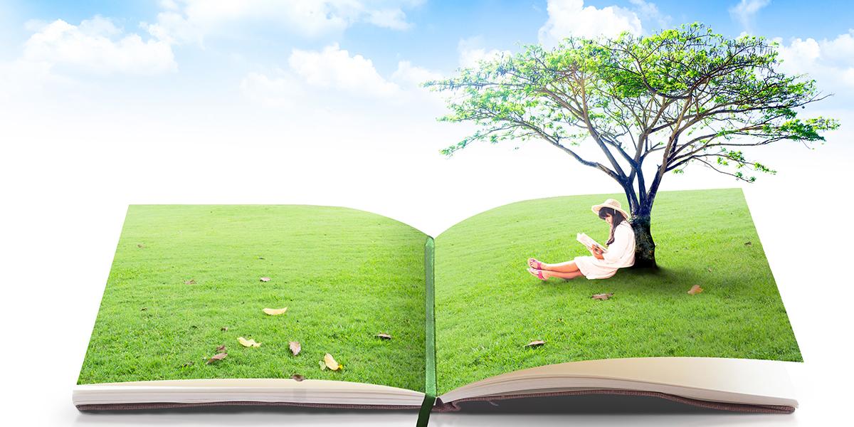 Child reading and sitting under a tree coming out of an open book