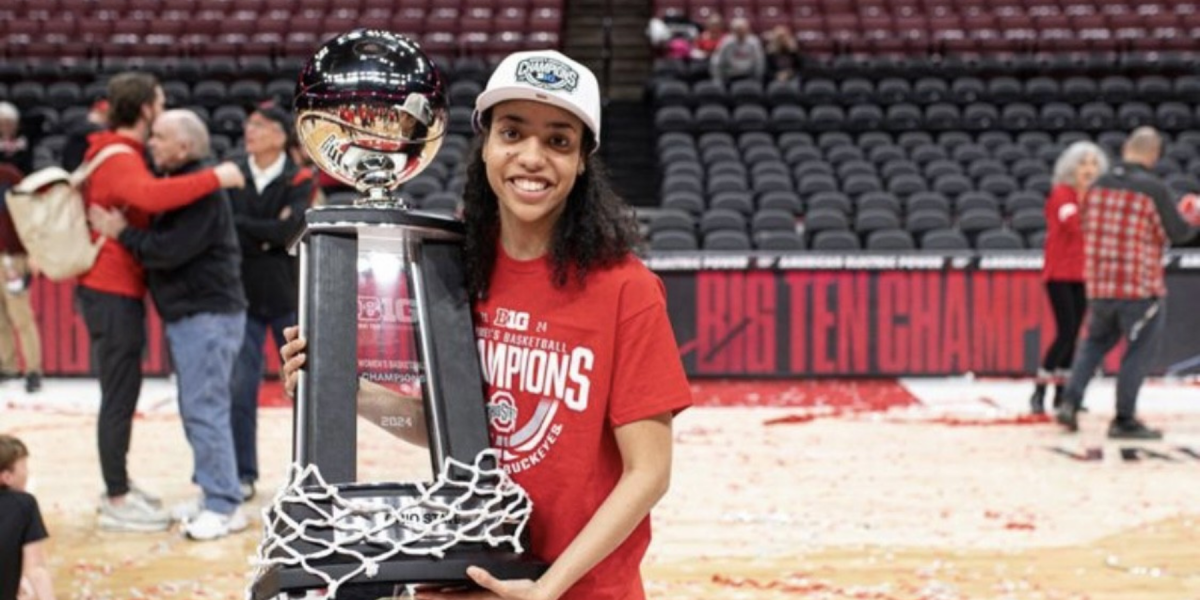 Shelby Granger holds the 2024 Big Ten Women's Basketball Championship trophy