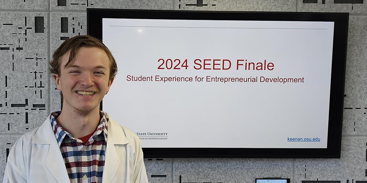 Liam Moore in a white lab coat at the 2024 SEED Finale