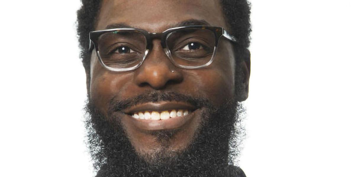 Peter Odulwole, a Black man, in glasses and a beard and mustache