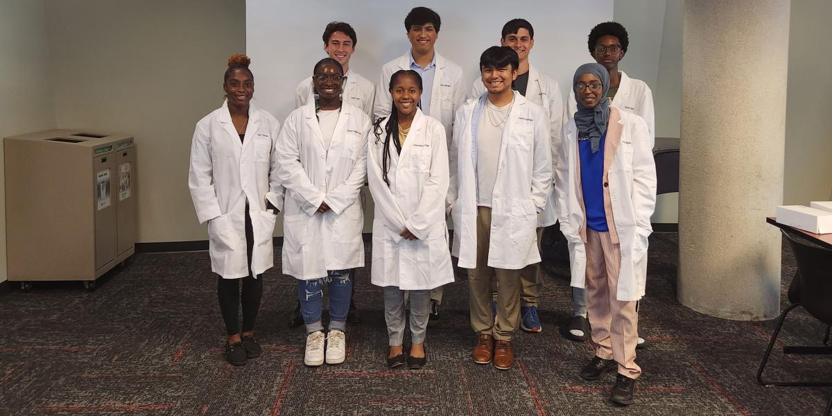 Group of students in white lab coats