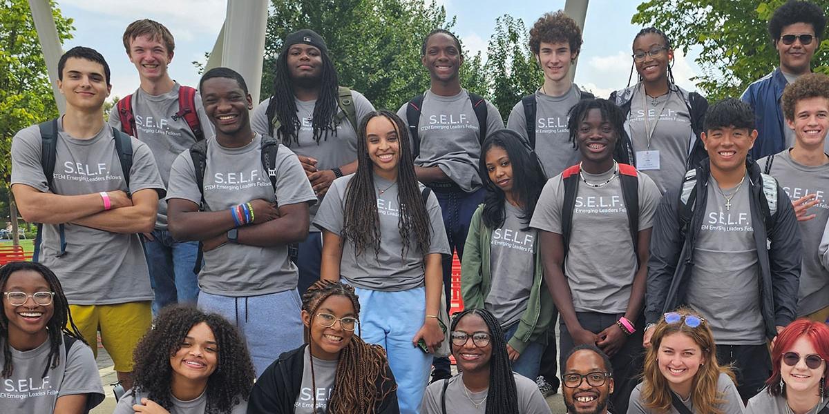 Male and female participants in matching grey t-shirts