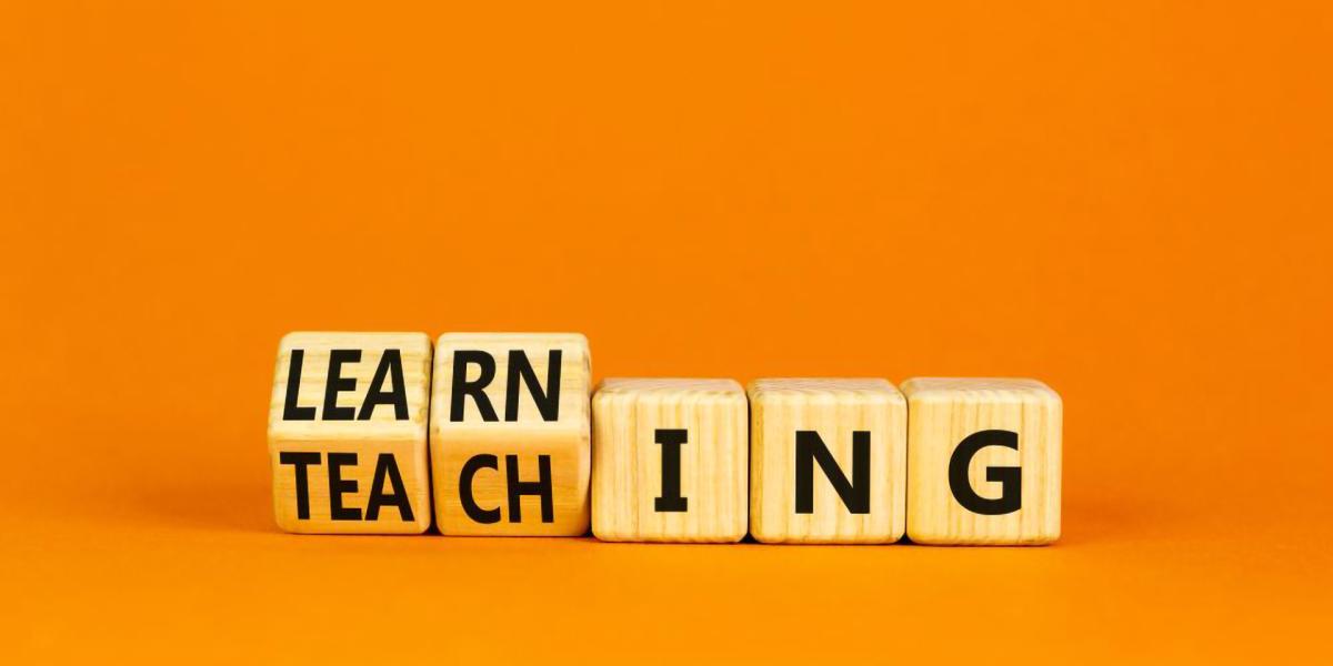 wooden block that say teaching turning into learning