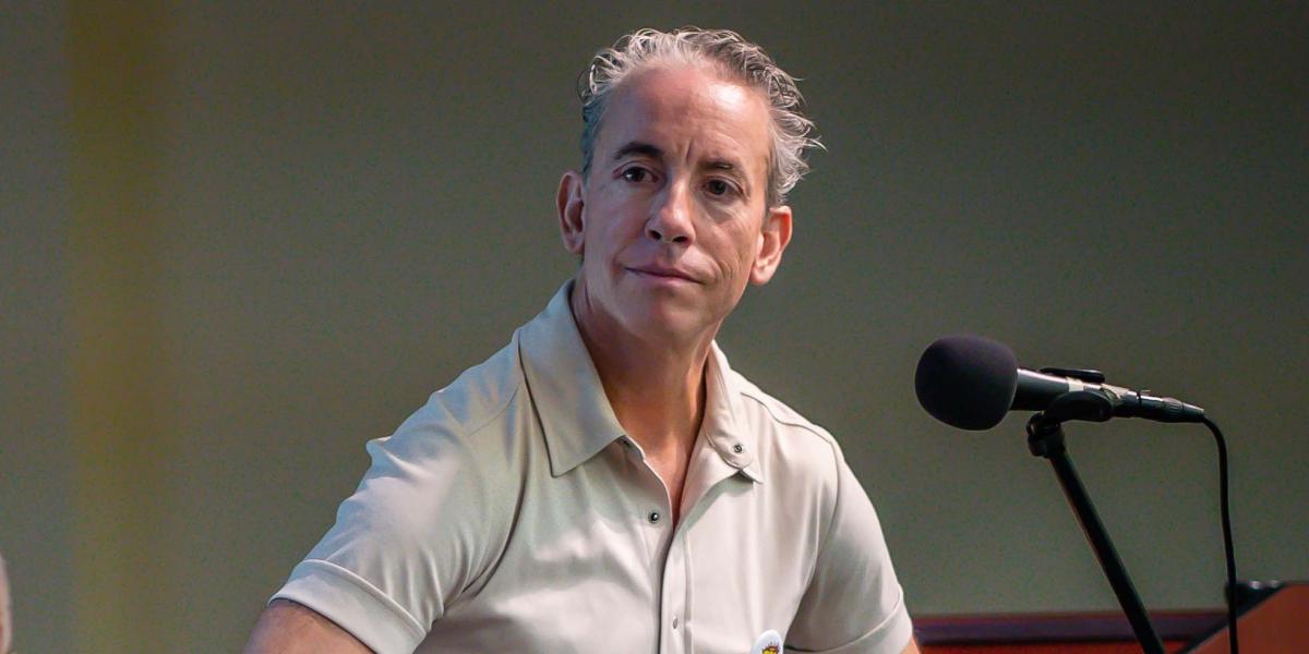 Frederic Aldama sits before a mic