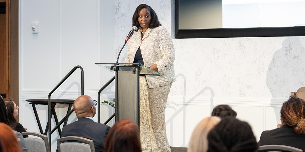 Lisa Cook, a Black woman, speaks at a podium