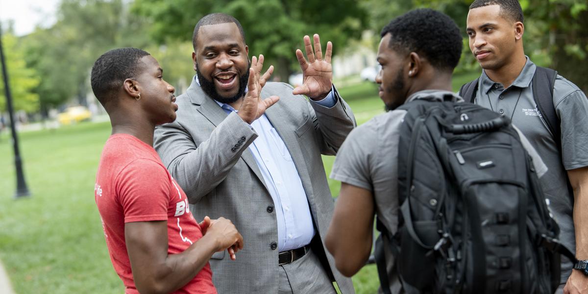 Dan Thomas speaks with several young Black males on Ohio State's campus