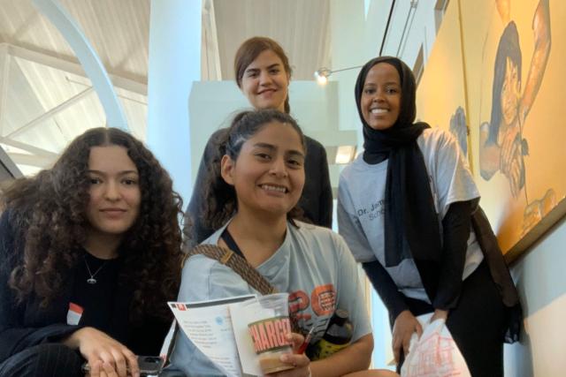 Four diverse girls smile into the camera