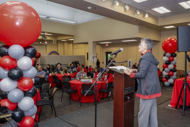 Yolanda Zepeda speaks to ODI Homecoming attendees in scarlet and grey.