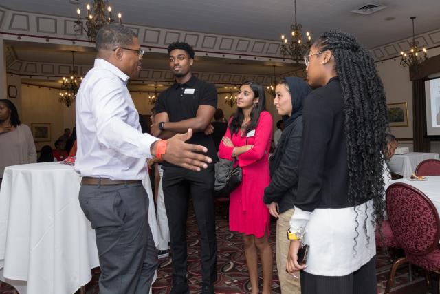 group of people gesturing while talking