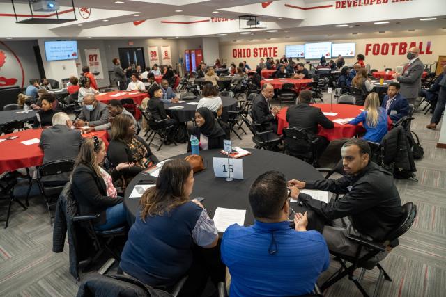 Participants in the ODI Diversity Networking Mixer sit around tables and talk