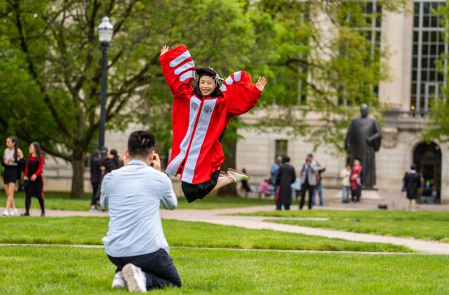 Graduating phd student jumps up into the air!