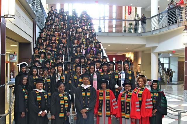 Large group of graduates stand on the steps of the Ohio Union for Afrikan Farewell Celbration