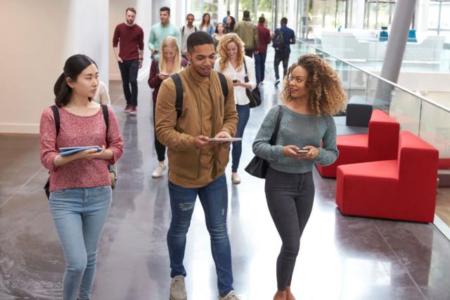 Students walking in college building with bookbags