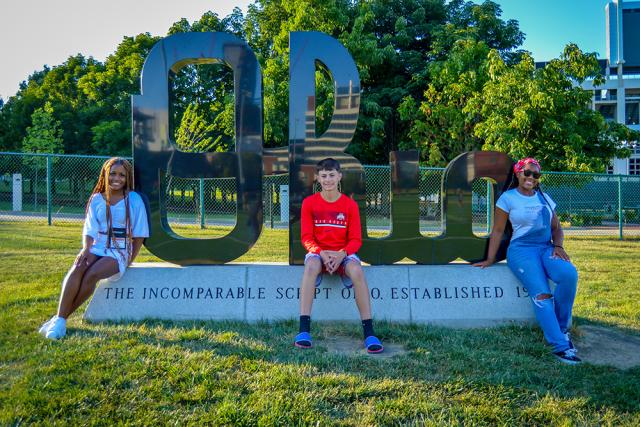 Three YSP sit on an Ohio Sign