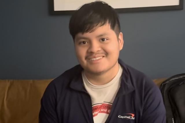 Jared Alonzo, with dark hair, in a Capitol One jacket and t-shirt