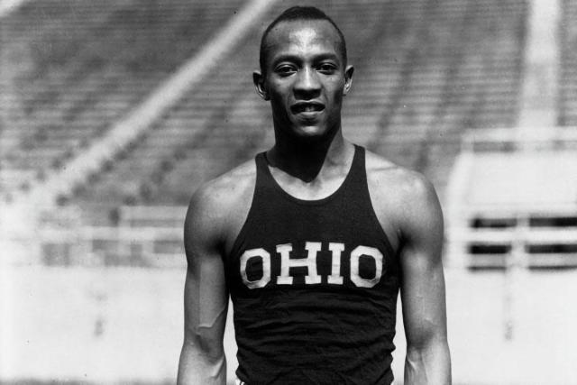  Jesse Owens in a track suit top that says OHIO