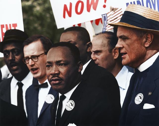 MLK and other at a march carrying signs