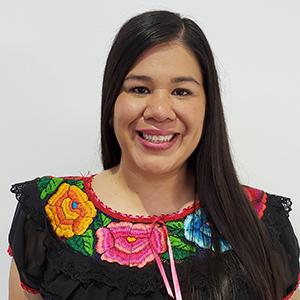 Mónica Ramírez, JD om a brightly collared black blouse