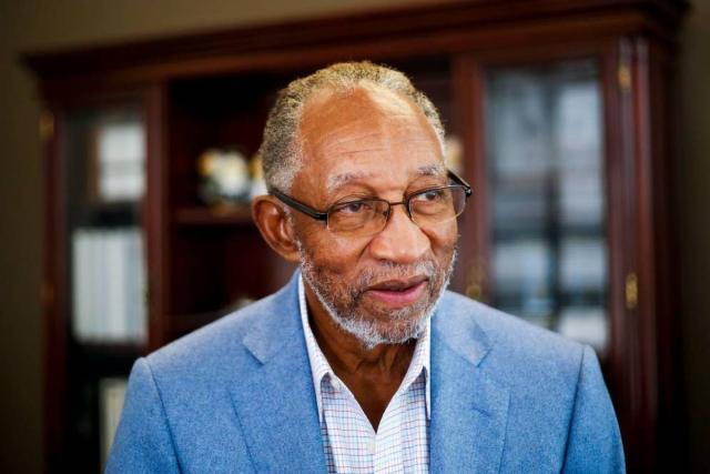 Robert L. Wright Jr., OD in a light blue jacket and white open collared shirt