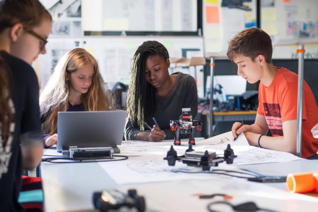 Students work together on a small robot