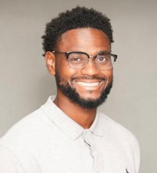 Te’vion Gilbreath in a white polo, glasses and a beard