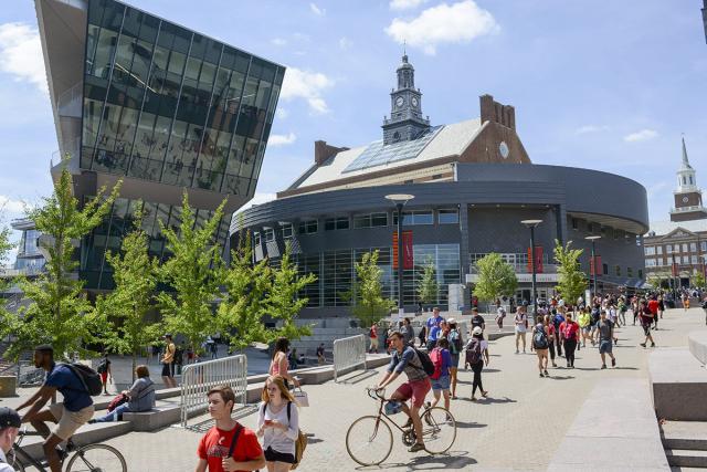 University of Cincinnati campus with students walking and cycling