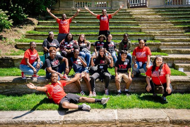 YSP students in Ohio State and YSP t-hirts sit on the Ohio State Ampitheater