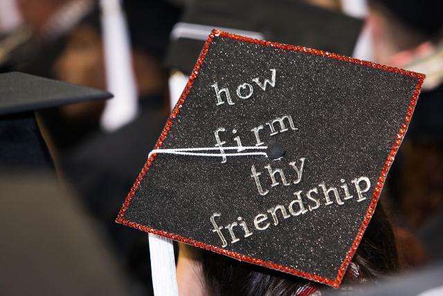 Ohio State grad cap with "How firm thy friendship" written on it