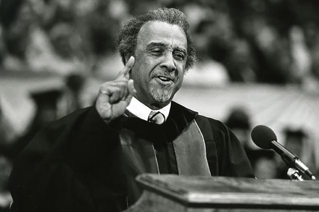 Frank W. Hale Jr., PhD in PhD robe speaking at Ohio State commencement