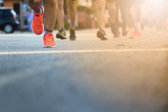 runners' shoes hitting the pavement