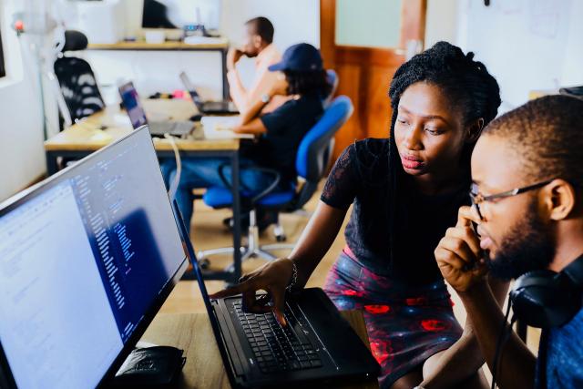 Woman helping a student at a computer