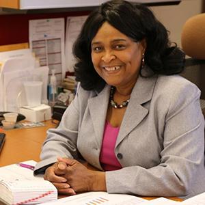 Minnie McGee sits at her desk